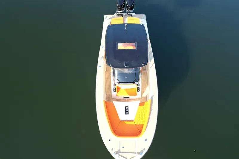 Slide: The Image of 2026 Lilybaeum Lipari 31 boat docked on calm water, modern building in background. - 13