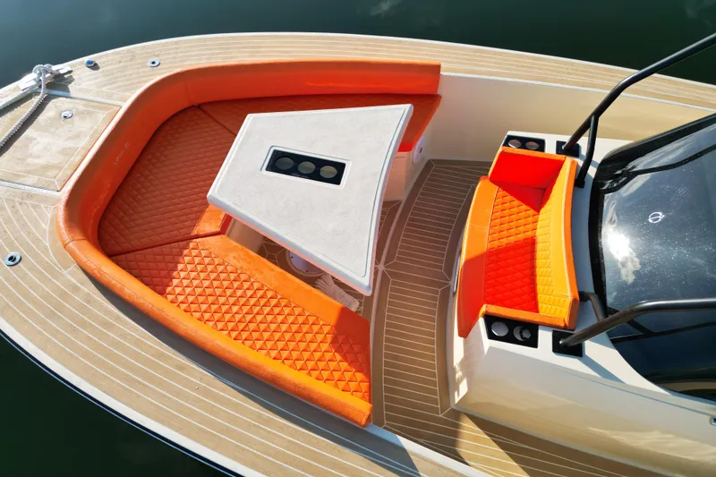 Slide: The Image of 2026 Lilybaeum Lipari 31 boat with orange seating and sleek design on calm water. - 15
