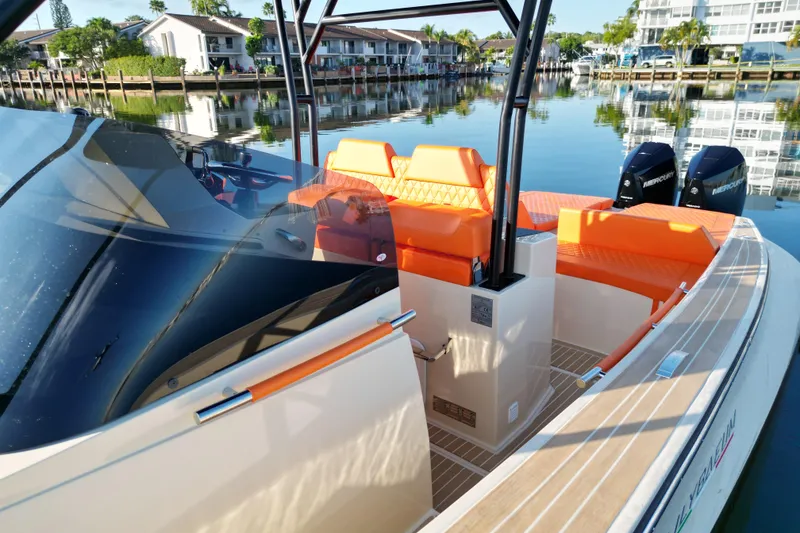Slide: The Image of 2026 Lilybaeum Lipari 31 boat with orange seating, modern design, and waterfront view. - 17