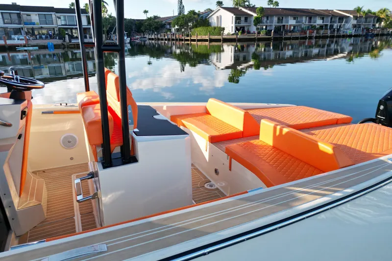 Slide: The Image of 2026 Lilybaeum Lipari 31 boat with orange seating, anchored on calm water. - 18