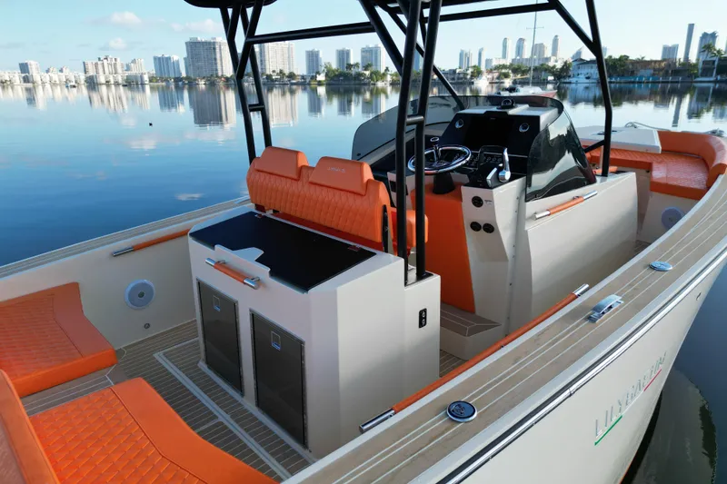 Slide: The Image of 2026 Lilybaeum Lipari 31 boat with vibrant orange seating, docked in a serene marina. - 19