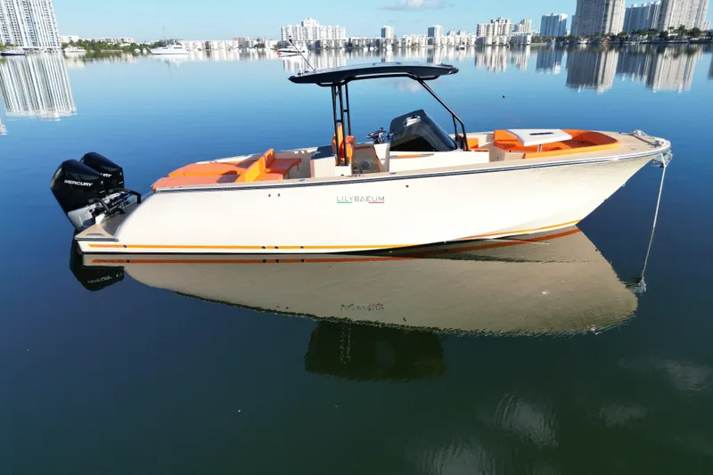 Slide: The Image of 2026 Lilybaeum Lipari 31 boat on calm water with city skyline background. - 2