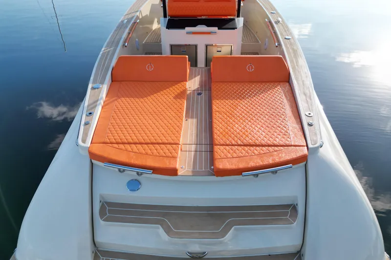 Slide: The Image of 2026 Lilybaeum Lipari 31 boat with orange seating, sleek design, and waterfront cityscape. - 24