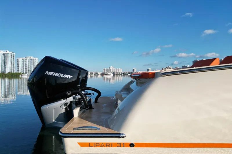 Slide: The Image of 2026 Lilybaeum Lipari 31 boat with dual Mercury engines, docked in calm waters. - 29