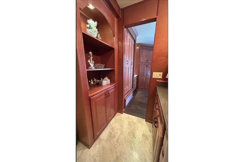 Slide: The Image of Luxurious wooden cabinetry in a 2007 Sharpe 18 x 90 houseboat interior hallway. - 11