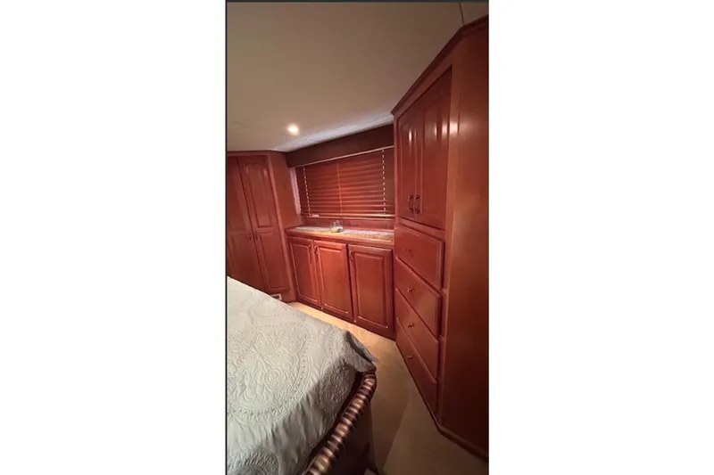 Slide: The Image of Luxurious wooden interior of 2007 Sharpe 18 x 90 houseboat bedroom with cabinets and bed. - 14