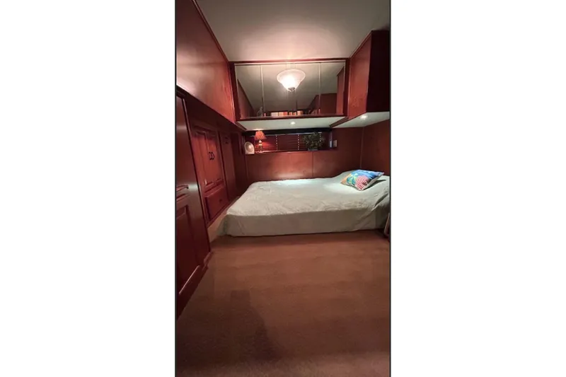Slide: The Image of Cozy bedroom with wooden walls in a 2007 Sharpe 18 x 90 houseboat. - 15