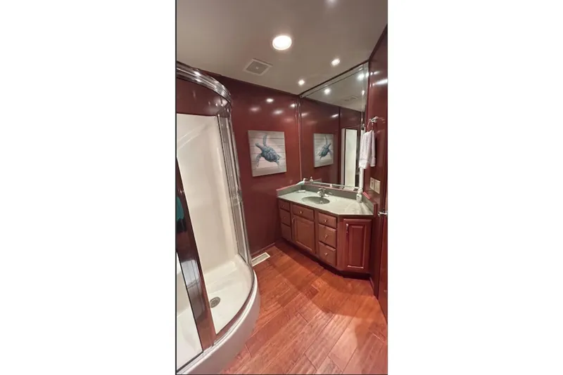 Slide: The Image of Luxurious bathroom with wood accents, corner shower, and elegant vanity in a 2007 Sharpe 18 x 90. - 16