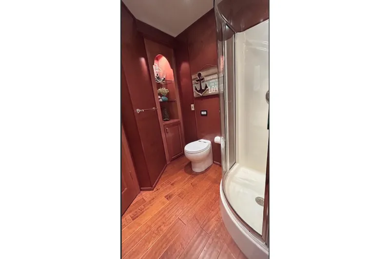 Slide: The Image of Luxurious bathroom with wooden flooring, glass shower, and decorative shelving in a 2007 Sharpe 18 x 90. - 17