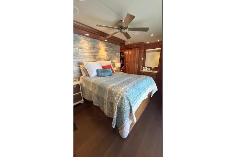 Slide: The Image of Cozy bedroom with wooden accents, ceiling fan, and patterned bedding on a Sharpe 18 x 90 houseboat. - 20
