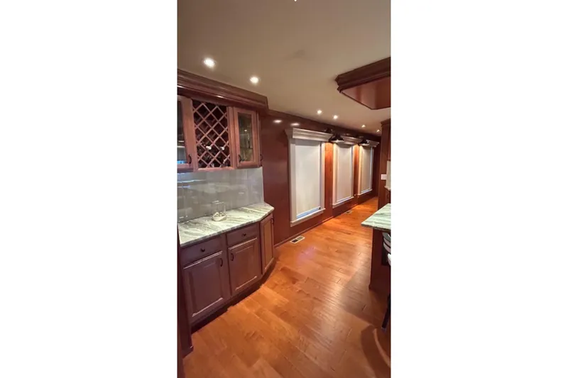 Slide: The Image of Luxurious interior of 2007 Sharpe 18 x 90 with wood flooring and elegant cabinetry. - 6