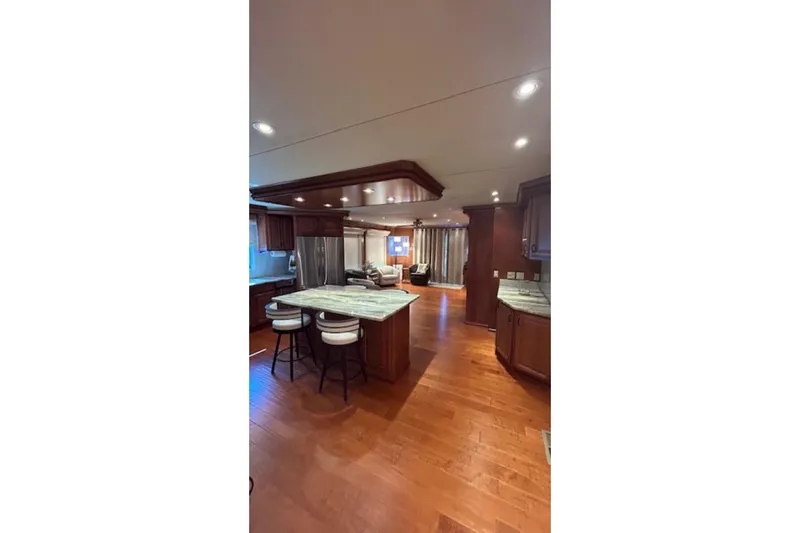 Slide: The Image of Luxurious kitchen interior on a 2007 Sharpe 18 x 90 houseboat with wooden flooring. - 7