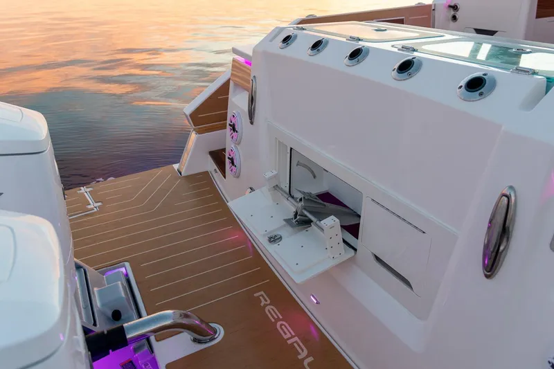Slide: The Image of 2026 Regal LX43 boat deck with modern features at sunset. - 11