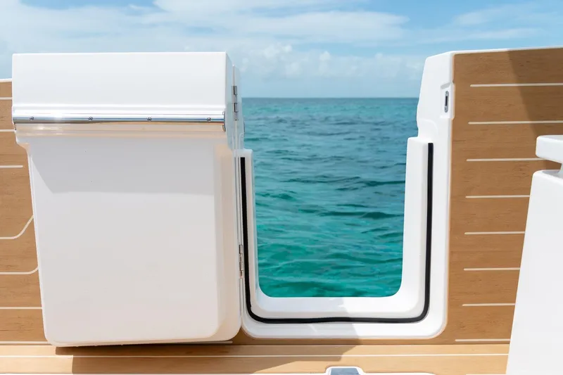 Slide: The Image of 2026 Regal LX43 boat with open deck gate overlooking the ocean. - 12
