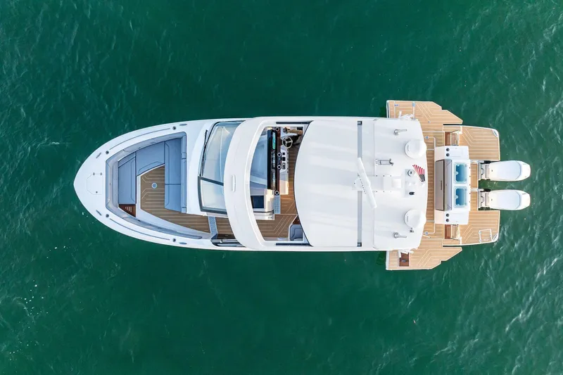 Slide: The Image of Aerial view of 2026 Regal LX43 yacht on clear blue water. - 2