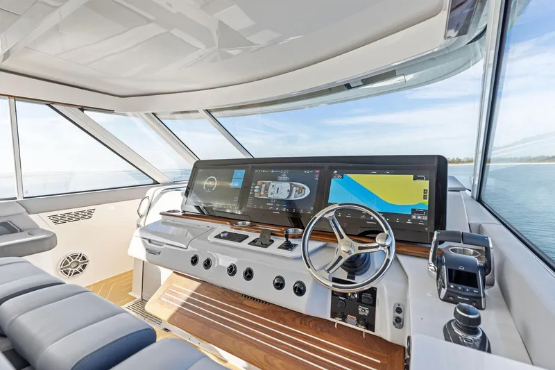 Slide: The Image of Modern helm of 2026 Regal LX43 yacht with advanced navigation displays and controls. - 29