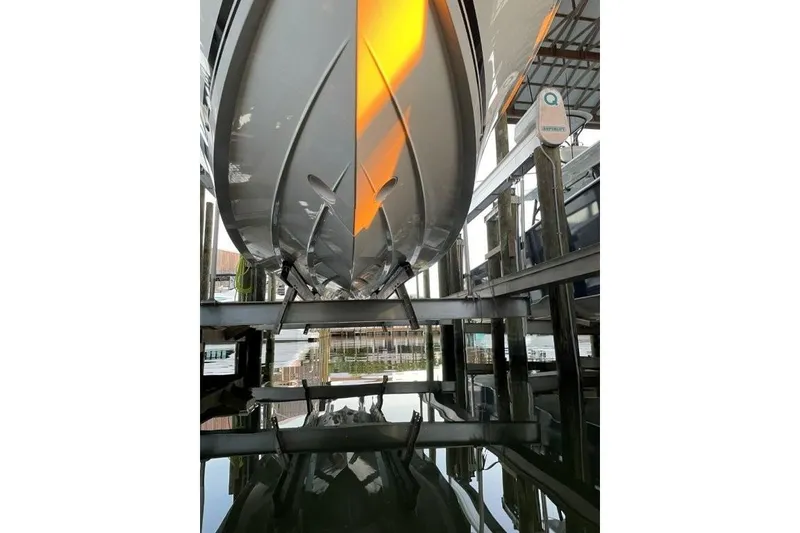 Slide: The Image of 2023 Pursuit S 358 Sport boat hull in marina, reflecting on water. - 12