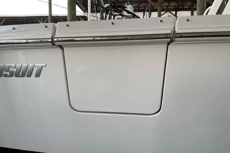 Slide: The Image of 2023 Pursuit S 358 Sport boat, close-up of sleek white exterior with logo. - 13