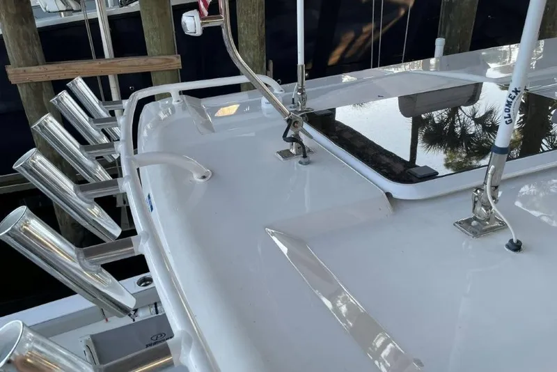 Slide: The Image of 2023 Pursuit S 358 Sport boat deck with rod holders and railing. - 18