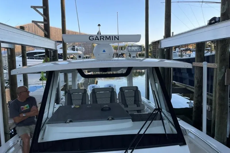 Slide: The Image of 2023 Pursuit S 358 Sport boat docked with Garmin equipment visible. - 20