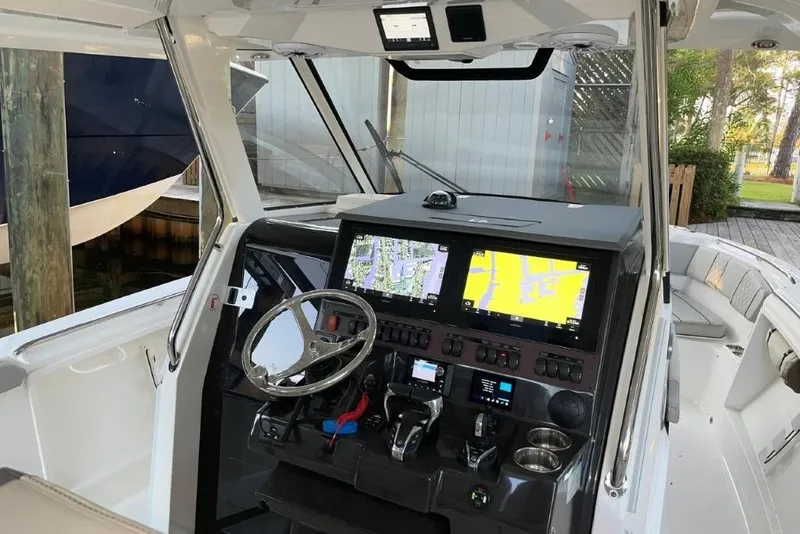 Slide: The Image of 2023 Pursuit S 358 Sport boat cockpit with advanced navigation displays and controls. - 23