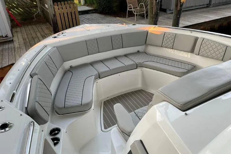 Slide: The Image of 2023 Pursuit S 358 Sport boat with luxurious gray seating and spacious deck area. - 3