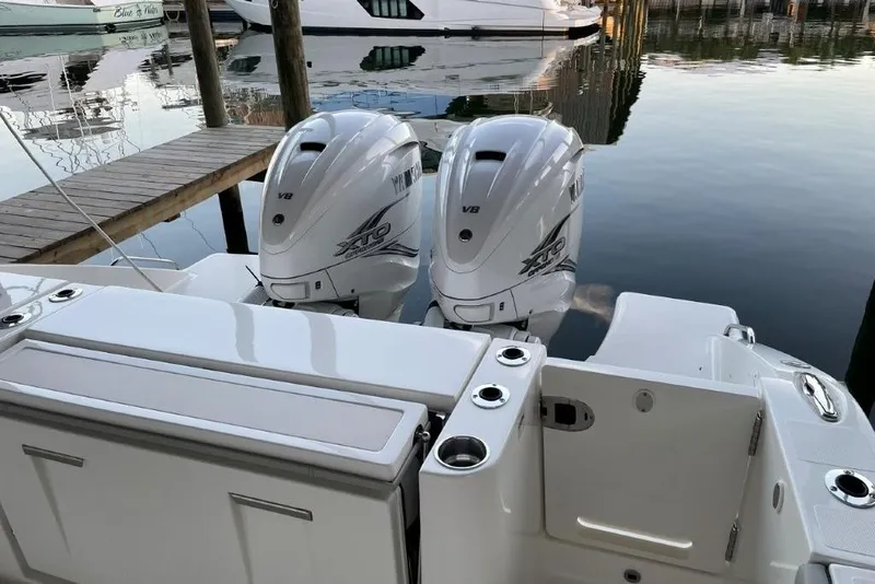 Slide: The Image of 2023 Pursuit S 358 Sport boat with twin outboard engines docked at marina. - 4