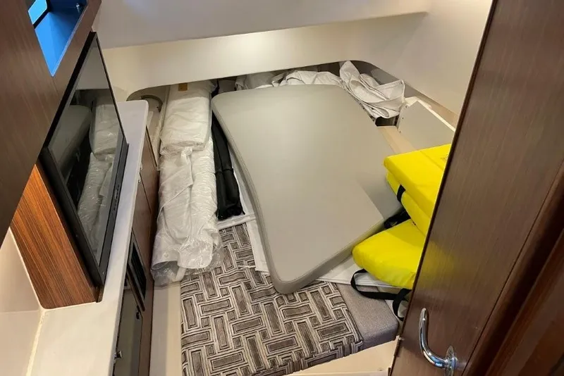 Slide: The Image of Interior cabin of 2023 Pursuit S 358 Sport boat with cushions and storage. - 6