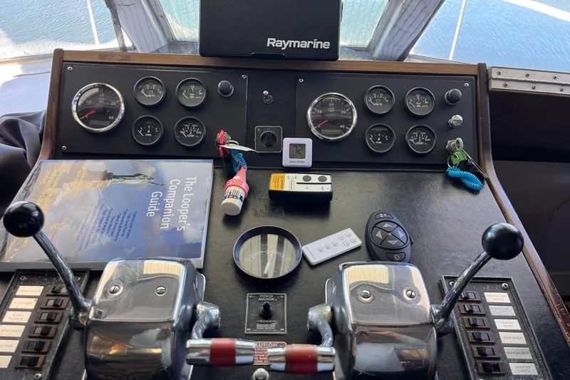 Slide: The Image of 1972 Whitcraft houseboat dashboard with controls, gauges, and navigation equipment. - 2