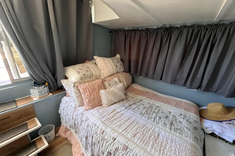 Slide: The Image of Cozy bedroom interior of a 1972 Whitcraft houseboat with elegant bedding and curtains. - 21