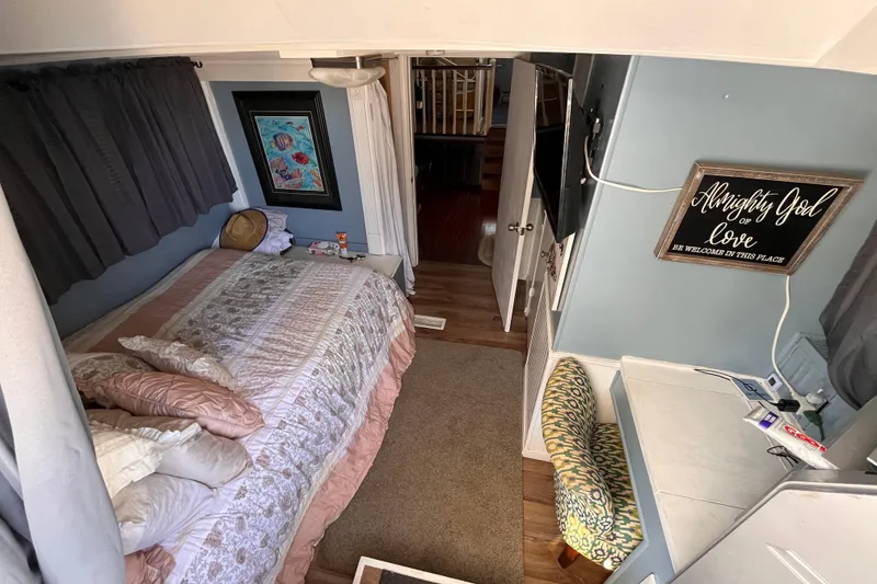 Slide: The Image of Cozy 1972 Whitcraft houseboat bedroom with bed, decor, and inspirational wall art. - 23