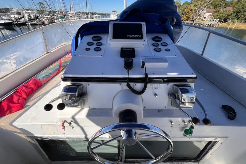 Slide: The Image of 1972 Whitcraft houseboat helm with steering wheel, controls, and navigation equipment. - 25