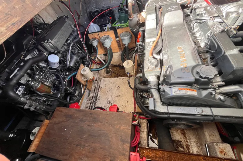 Slide: The Image of Engine compartment of a 1972 Whitcraft houseboat, showcasing dual engines and mechanical components. - 31