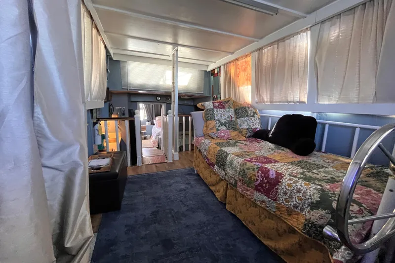 Slide: The Image of 1972 Whitcraft houseboat interior with cozy seating and colorful quilted decor. - 6
