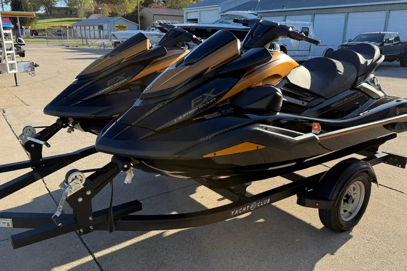The Image of 2024 Yamaha WaveRunner FX Limited SVHO jet skis on a trailer in a parking lot. - 0