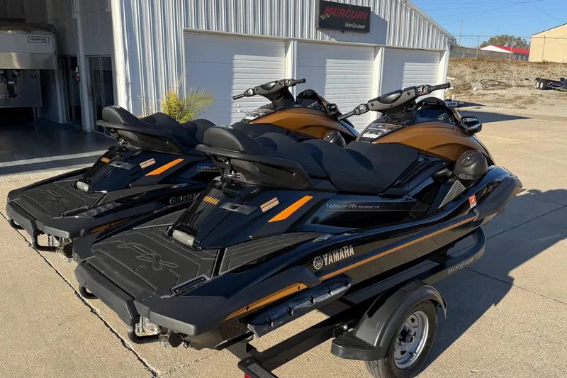 Slide: The Image of 2024 Yamaha WaveRunner FX Limited SVHO jet skis on trailer, parked outside dealership. - 3