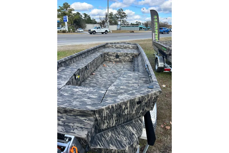Slide: The Image of 2025 Havoc 1756 MRST boat with camouflage design on display outdoors. - 2