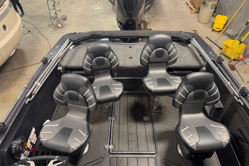 Slide: The Image of 2024 Nitro ZV19 Sport boat interior with four sleek black seats in a workshop setting. - 12