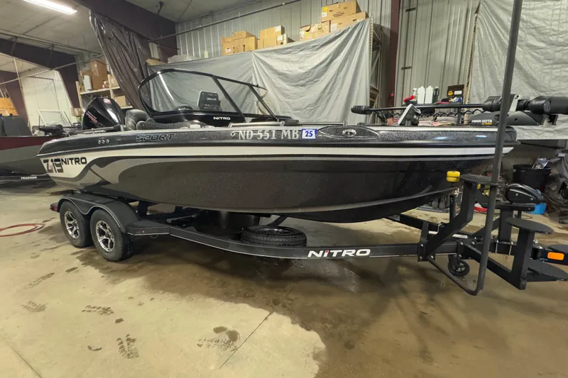 Slide: The Image of 2024 Nitro ZV19 Sport boat on trailer in indoor storage facility. - 2