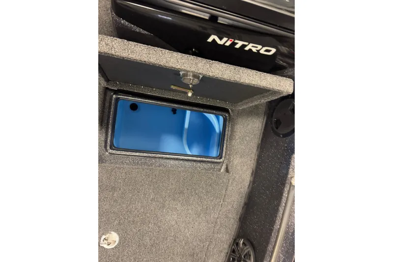 Slide: The Image of 2024 Nitro ZV19 Sport boat storage compartment with open lid, showcasing interior space. - 20