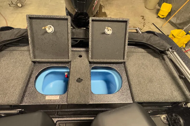 Slide: The Image of 2024 Nitro ZV19 Sport boat with open storage compartments and blue interior. - 23