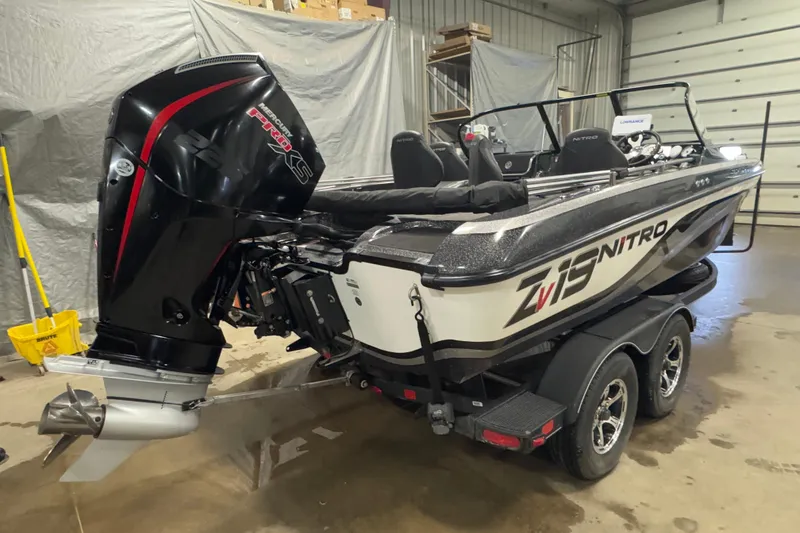 Slide: The Image of 2024 Nitro ZV19 Sport boat with powerful engine in a garage setting. - 3