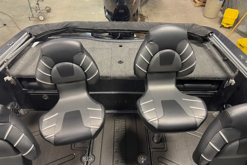 Slide: The Image of 2024 Nitro ZV19 Sport boat interior with sleek black and gray seating. - 6