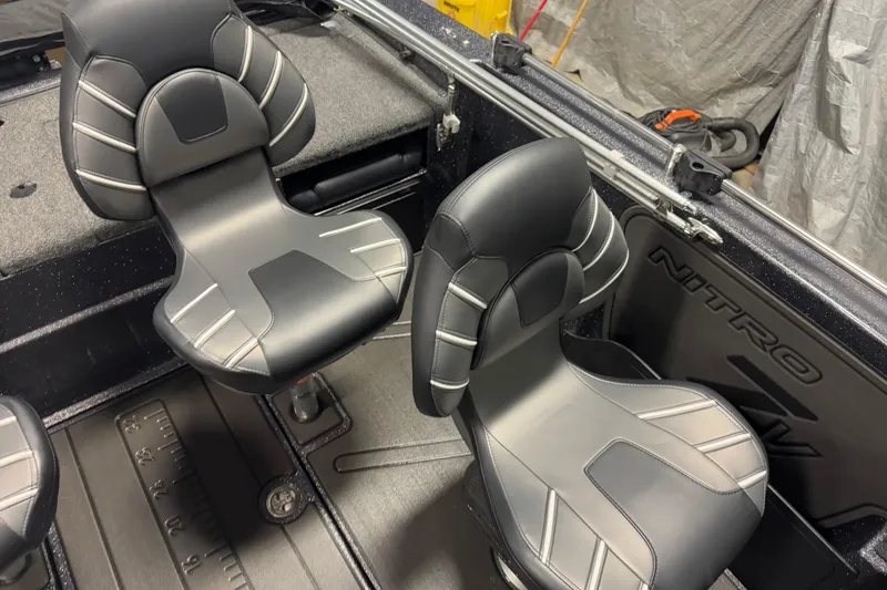 Slide: The Image of 2024 Nitro ZV19 Sport boat interior with sleek black and gray seating. - 8