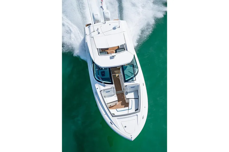 Slide: The Image of Manufacturer Provided Image: 2025 Tiara Yachts 34 LX cruising on clear turquoise water, aerial view. - 4
