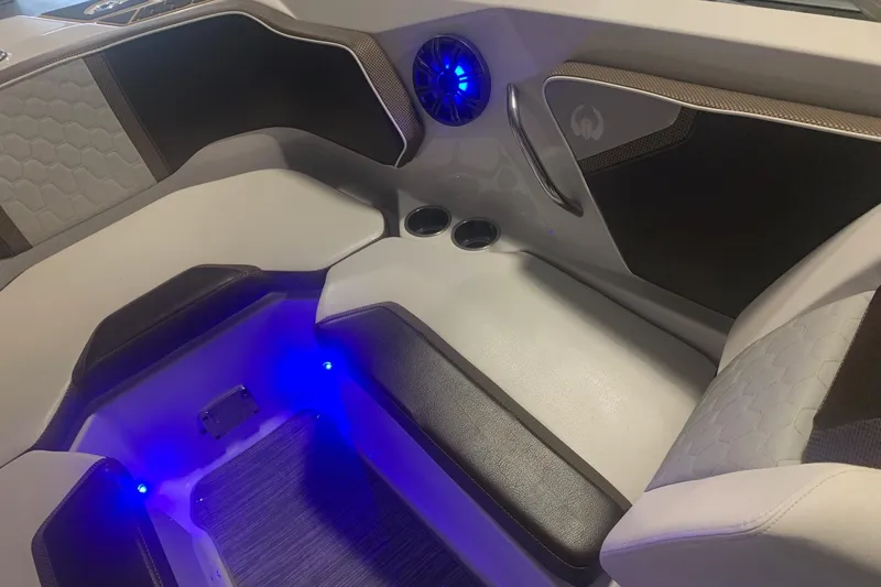 Slide: The Image of Interior of 2019 Scarab 255 Wake ID boat with blue LED lighting and modern seating. - 11
