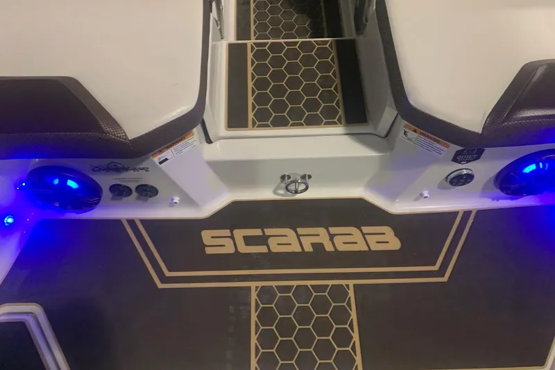 Slide: The Image of 2019 Scarab 255 Wake ID boat interior with illuminated speakers and honeycomb design. - 15