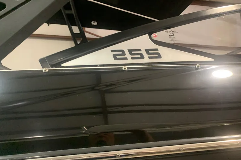 Slide: The Image of 2019 Scarab 255 Wake ID boat, sleek black exterior with model number visible. - 2