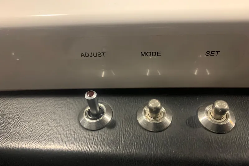 Slide: The Image of Control panel of 2019 Scarab 255 Wake ID with adjust, mode, set switches. - 21