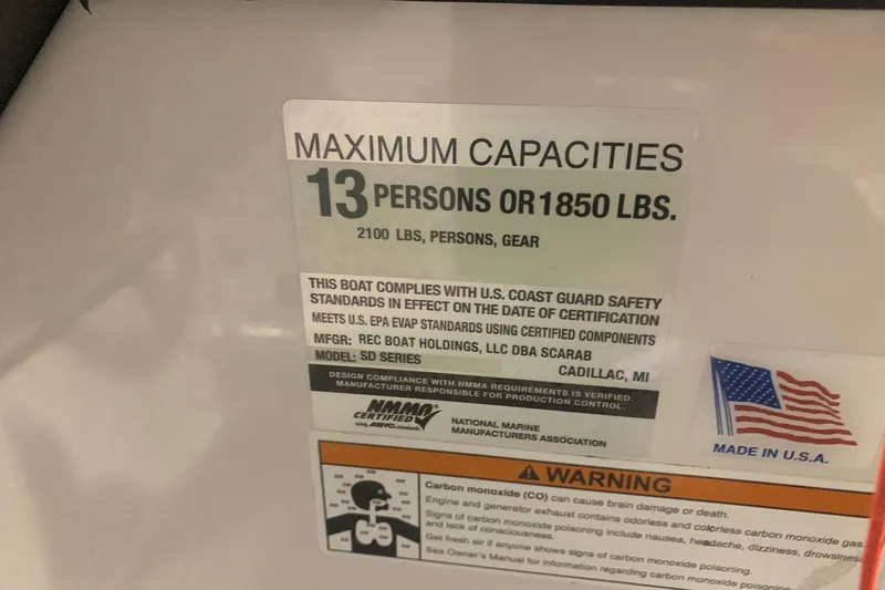 Slide: The Image of 2019 Scarab 255 Wake ID capacity label, 13 persons or 1850 lbs, safety compliance details. - 22